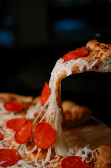 Chef cooking on a large flat-top grill in a warm, industrial kitchen setting